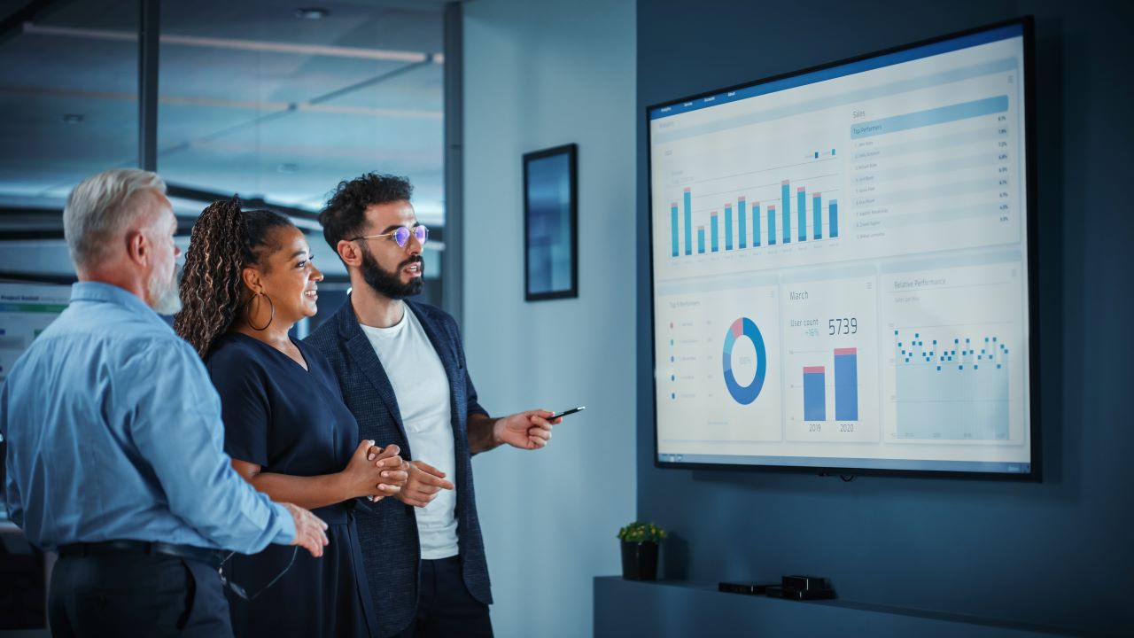 A small marketing team looks at data-driven marketing results.